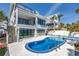 Bright pool area features a sparkling blue pool, spa, and outdoor entertaining space at 8505 Blind Pass Dr, Treasure Island, FL 33706