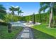 Manicured backyard with stone walkway leading to a private in-ground pool and lounging area at 866 S Davis Blvd, Tampa, FL 33606