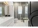 Bright bathroom boasts gray tile walls with decorative accents, with a combination shower and tub at 866 S Davis Blvd, Tampa, FL 33606