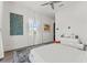 Bright bedroom featuring white walls, ceiling fan, and stylish accent artwork at 866 S Davis Blvd, Tampa, FL 33606