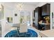 Cozy dining area with a glass table, white chairs, and views of the backyard at 866 S Davis Blvd, Tampa, FL 33606