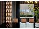 Modern dining room with a long, black table, designer wallpaper, and a built-in wine rack at 866 S Davis Blvd, Tampa, FL 33606