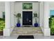 Inviting front entrance with double doors, elegant columns, and lush potted greenery at 866 S Davis Blvd, Tampa, FL 33606