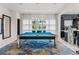 Bright game room featuring a blue felt pool table with chrome legs and modern light fixture at 866 S Davis Blvd, Tampa, FL 33606