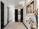 Elegant hallway with dark wood floors, classic artwork, and stylish black doors at 866 S Davis Blvd, Tampa, FL 33606
