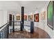Bright hallway with hardwood floors, modern art, elevator, and wrought iron details at 866 S Davis Blvd, Tampa, FL 33606