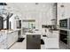 Modern kitchen features white cabinetry, stainless steel appliances, and a spacious island at 866 S Davis Blvd, Tampa, FL 33606