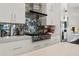 Close up shot of a modern kitchen with mosaic backsplash, stainless steel range, and white cabinetry at 866 S Davis Blvd, Tampa, FL 33606