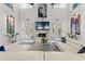 Bright living room features white leather sofas, high ceilings, and a marble fireplace at 866 S Davis Blvd, Tampa, FL 33606