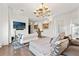 Large main bedroom featuring a seating area, modern chandelier, and hardwood flooring at 866 S Davis Blvd, Tampa, FL 33606