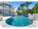 A luxurious in-ground pool features a waterfall, spa, and is surrounded by a patio at the rear of the home at 866 S Davis Blvd, Tampa, FL 33606