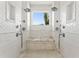 An elegant shower with double shower heads, white tile, and marble bench at 866 S Davis Blvd, Tampa, FL 33606
