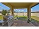 Outdoor patio with a stainless steel grill, brick floors, and a hammock at 9116 Grant Line Ln, Riverview, FL 33578