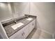 Bathroom featuring double vanity with granite counters and cabinets; a seamless blend of style and functionality at 11115 Wishing Cloud Rd, Land O Lakes, FL 34638