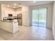 Modern kitchen featuring white cabinets, stainless steel appliances, and sliding glass doors to patio at 11115 Wishing Cloud Rd, Land O Lakes, FL 34638