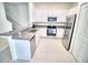 Bright kitchen with white cabinets, granite countertops, and stainless steel appliances at 11115 Wishing Cloud Rd, Land O Lakes, FL 34638
