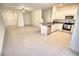 Spacious living room with open floor plan, featuring kitchen, dining, and tiled flooring at 11115 Wishing Cloud Rd, Land O Lakes, FL 34638