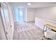 Upstairs loft area with soft carpeting, desk and chair, and natural light at 11115 Wishing Cloud Rd, Land O Lakes, FL 34638