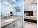 Well-lit bathroom with updated granite countertops and a view into the primary bedroom at 11116 Bloomington Dr, Tampa, FL 33635