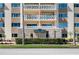 Facade of building called Shore Crest featuring an American Flag, multiple balconies, and beautiful architecture at 1200 N Shore Ne Dr # 110, St Petersburg, FL 33701