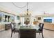Dining area with glass table and views into the living room at 1200 N Shore Ne Dr # 110, St Petersburg, FL 33701