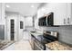 Modern kitchen featuring white cabinets, granite countertops, and stainless steel appliances at 1200 N Shore Ne Dr # 110, St Petersburg, FL 33701