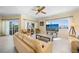 Living room with sliders to a balcony showing an outside seating area and a water view at 1200 N Shore Ne Dr # 110, St Petersburg, FL 33701