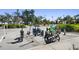 Various electric scooters and bicycles are parked neatly at a designated parking spot on a sunny day at 1200 N Shore Ne Dr # 110, St Petersburg, FL 33701