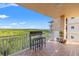 Spacious balcony offering stunning views of lush greenery and the ocean, complete with a bar table and stools at 12033 Gandy N Blvd # 175, St Petersburg, FL 33702