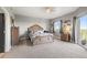 Inviting bedroom with neutral tones, features a large bed, dresser, and a window with scenic outdoor views at 12033 Gandy N Blvd # 175, St Petersburg, FL 33702