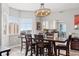 Bright dining room featuring a modern chandelier, wood floors, and large windows at 12033 Gandy N Blvd # 175, St Petersburg, FL 33702