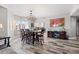 Bright dining room featuring a modern chandelier, wood floors, and large windows at 12033 Gandy N Blvd # 175, St Petersburg, FL 33702