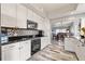 Bright kitchen featuring stainless steel appliances, black countertops, and white cabinets at 12033 Gandy N Blvd # 175, St Petersburg, FL 33702