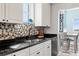Bright kitchen featuring stainless steel appliances, black countertops, and white cabinets at 12033 Gandy N Blvd # 175, St Petersburg, FL 33702