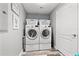 Laundry room with side-by-side washer and dryer on risers at 12033 Gandy N Blvd # 175, St Petersburg, FL 33702