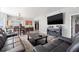 Spacious living room with large-screen TV, sleek furniture, and ample natural light at 12033 Gandy N Blvd # 175, St Petersburg, FL 33702