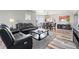 Open-concept living room featuring sleek leather seating, hardwood floors, and stylish decor at 12033 Gandy N Blvd # 175, St Petersburg, FL 33702