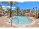 Community swimming pool and amenity area with lush landscaping on a clear day at 12033 Gandy N Blvd # 175, St Petersburg, FL 33702