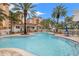 Community swimming pool surrounded by tall palm trees and tropical landscaping at 12033 Gandy N Blvd # 175, St Petersburg, FL 33702