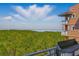 Balcony view overlooking lush green treetops and stunning views of the Gulf at 12033 Gandy N Blvd # 175, St Petersburg, FL 33702