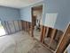 Unfinished bathroom with an open doorway features a toilet and shower ready for renovations at 12734 2Nd Isle, Hudson, FL 34667