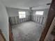 Unfinished bedroom featuring two windows and ceiling fan ready for renovations at 12734 2Nd Isle, Hudson, FL 34667