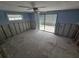 Unfinished bedroom featuring one window and a sliding glass door ready for renovations at 12734 2Nd Isle, Hudson, FL 34667