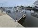 Wooden dock on the water features a dock extension with boat lift and water access at 12734 2Nd Isle, Hudson, FL 34667