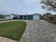 Charming single Gathering home with a well-maintained lawn and brick driveway in a sunny neighborhood at 12734 2Nd Isle, Hudson, FL 34667