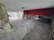 Unfinished living room featuring large windows and an stone fireplace ready for renovations at 12734 2Nd Isle, Hudson, FL 34667