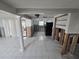 View of the living room with a large window, ceiling fan, tile flooring and exposed walls at 12734 2Nd Isle, Hudson, FL 34667