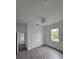 Bright bedroom featuring wood-look tile, a modern light fixture and a double door closet at 14300 Kay Ln, Port Charlotte, FL 33981