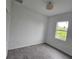 Bedroom with wood-look tile, double door closet and bright window at 14300 Kay Ln, Port Charlotte, FL 33981
