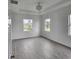 Large bedroom featuring many windows, tray ceilings, and wood-look tile at 14300 Kay Ln, Port Charlotte, FL 33981